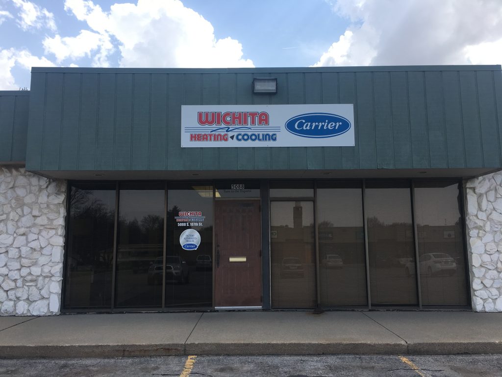 wichita heating and cooling storefront with green awning